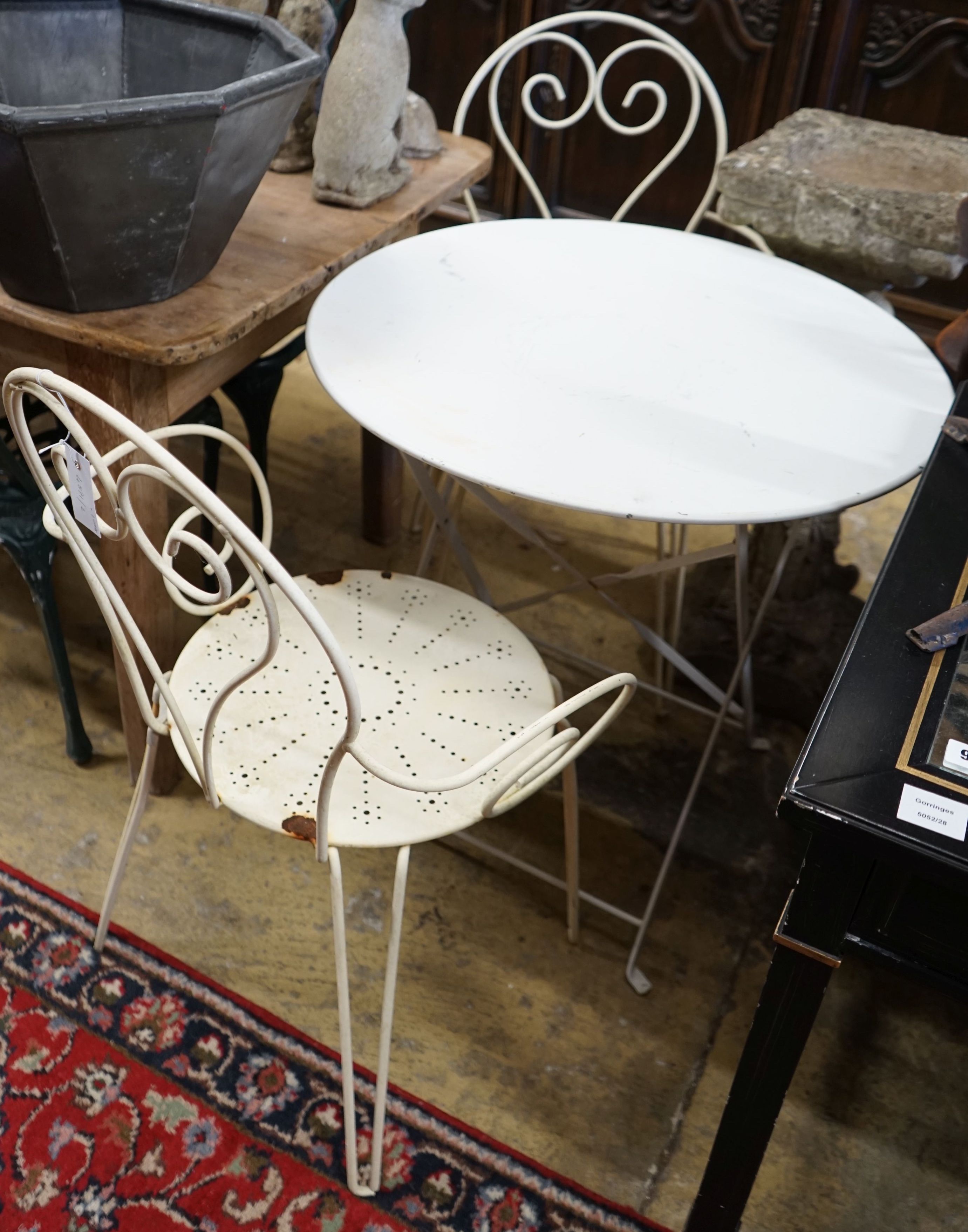 A circular metal folding bistro table, diameter 70cm, height 72cm and two chairs